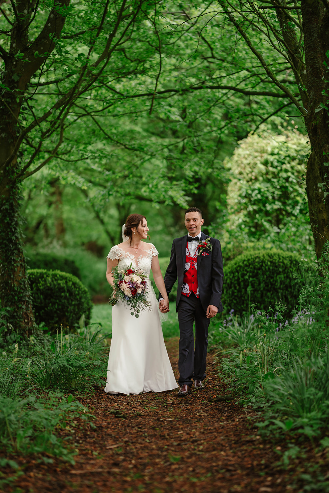 Bride and Groom surrounded by trees and shrubs