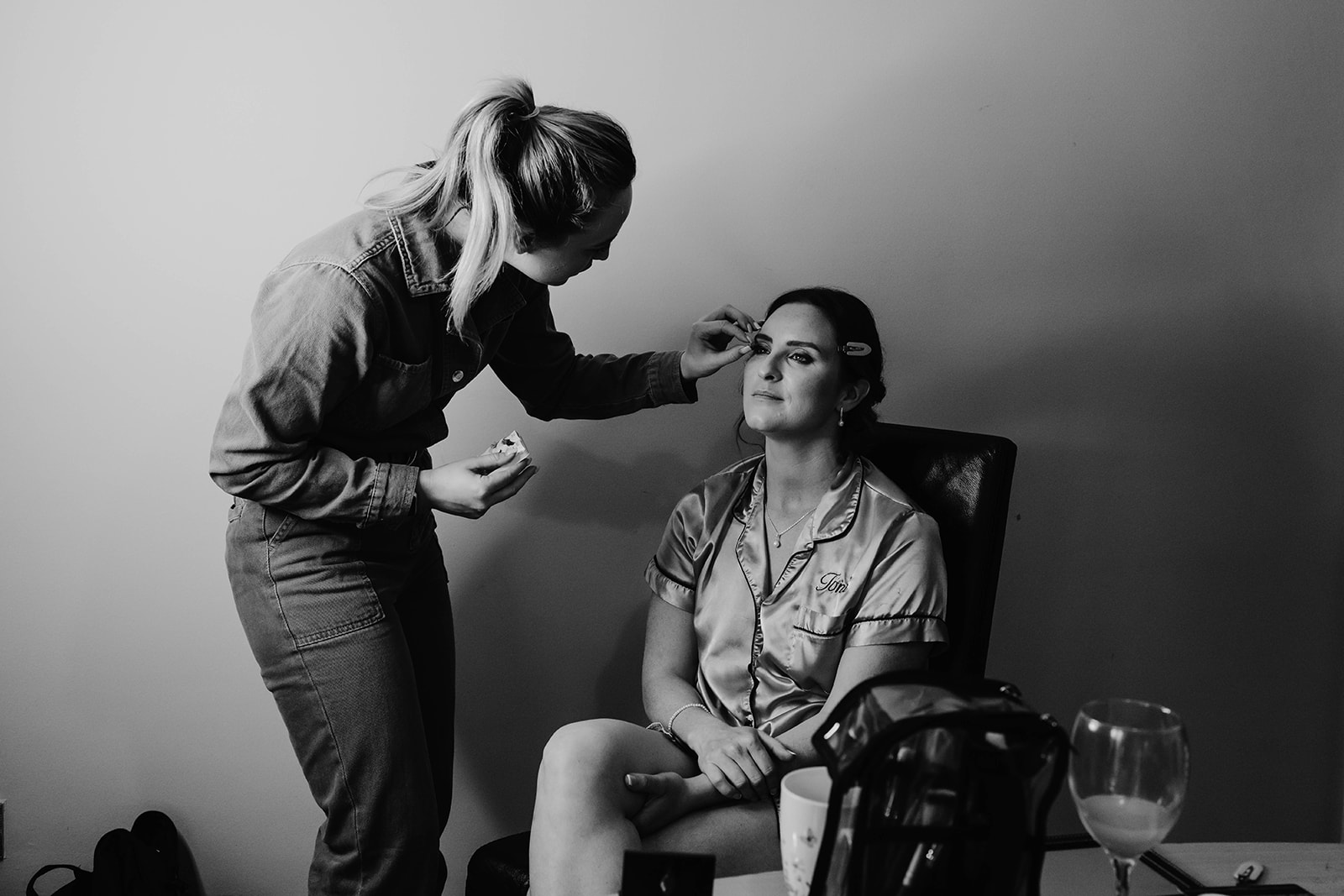 bride having her make-up done in Cirencester in black and white