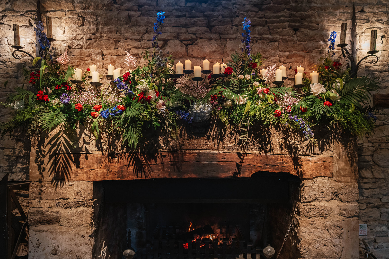 Fireplace at Cripps barn with flowers and candles