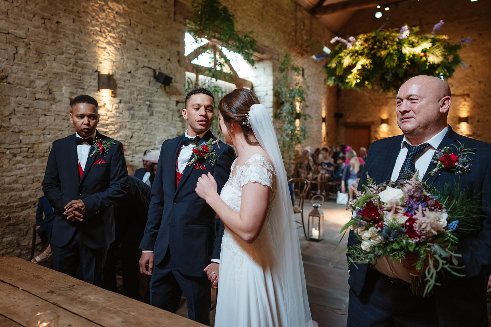 Groom and bride greet each other during ceremony at cripps barn