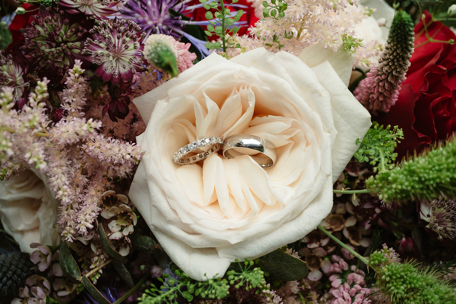 Weddings rings nestled in white rose. Bouquet by Lynne Jessett Floristry
