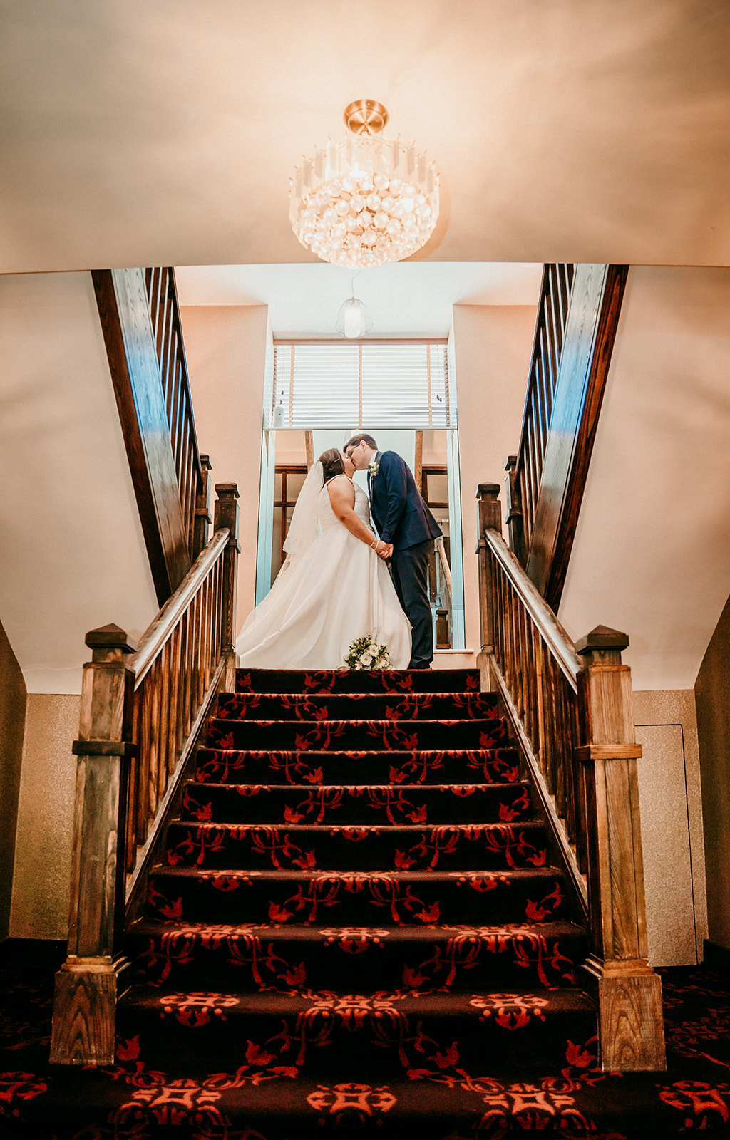 Elle and Andrew at the staircase in the redcastle hotel for their wedding