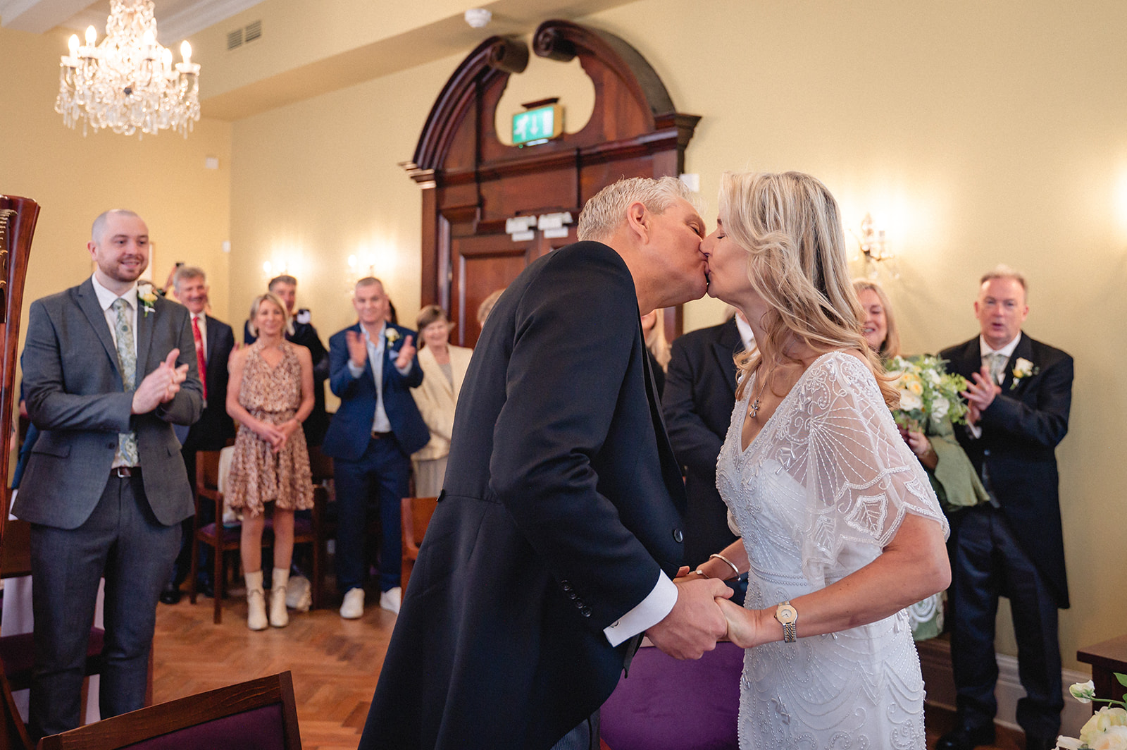 Lindsay and David kissing during the wedding ceremony in the Brydon Room at Chelsea Town Hall
