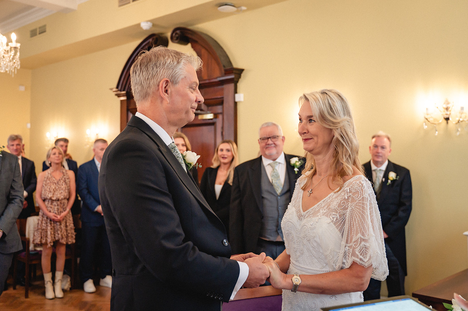 Lindsay and David's exchanging vows during the wedding ceremony in the Brydon Room at Chelsea Town Hall