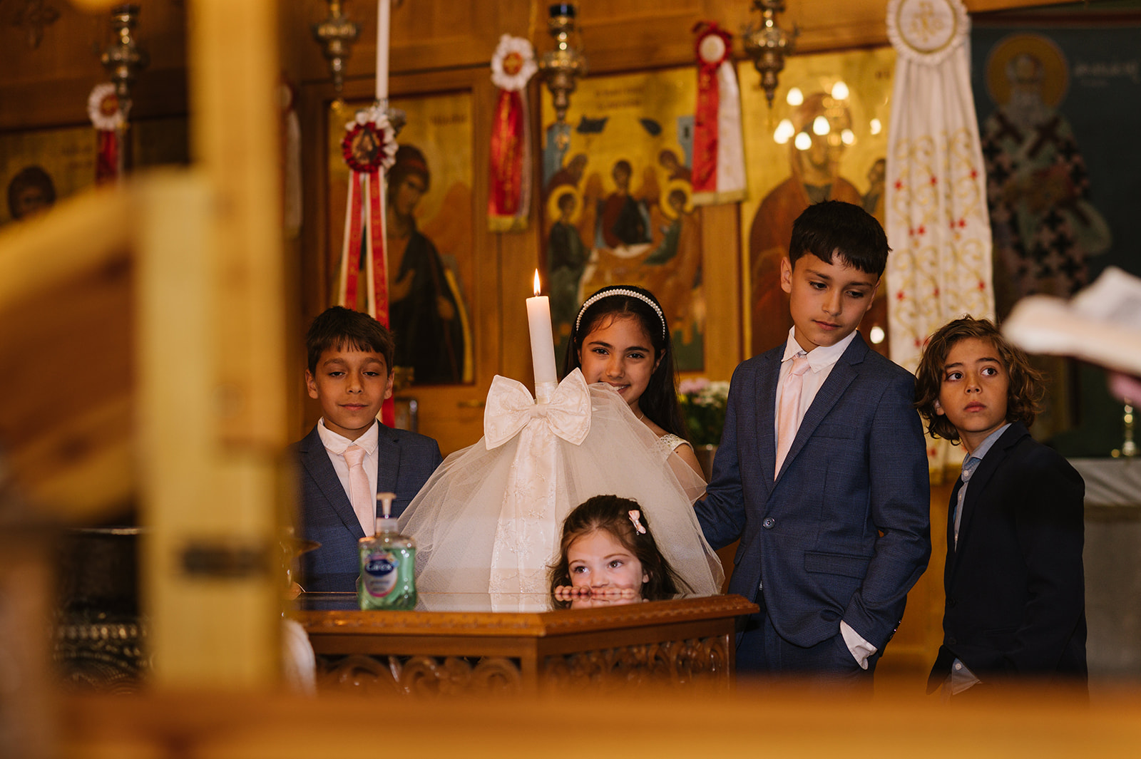 Children help in the ceremony at a greek orthodox christening