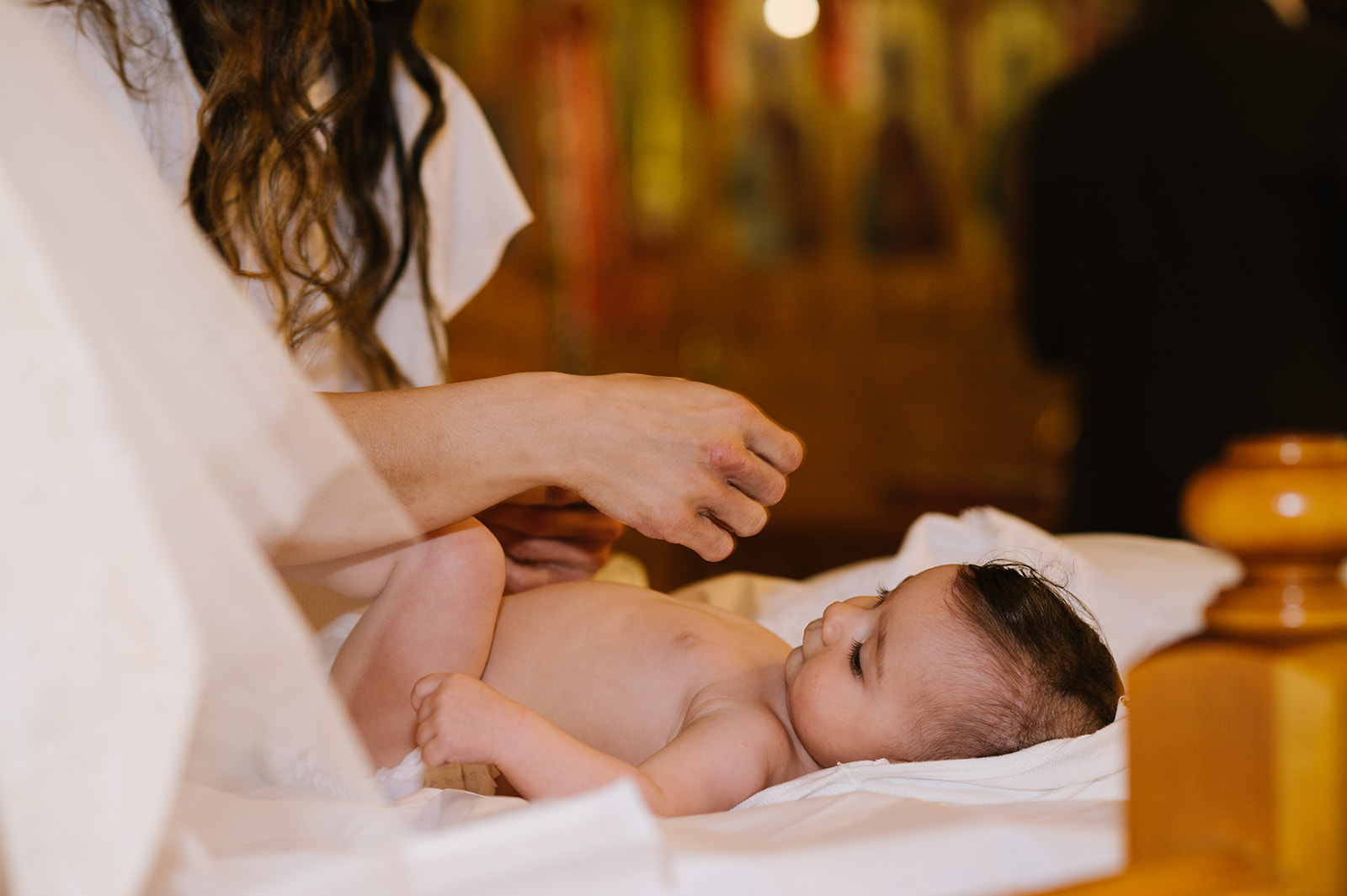 dressing the baby for her greek orthodox christening