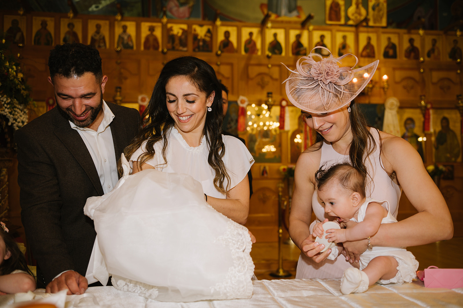 dressing the baby for her greek orthodox christening