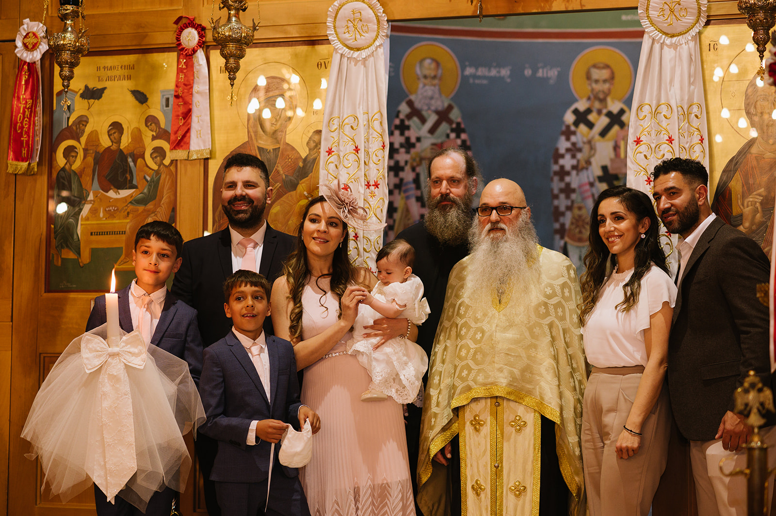 family group photos with the priest at a greek orthodox christening