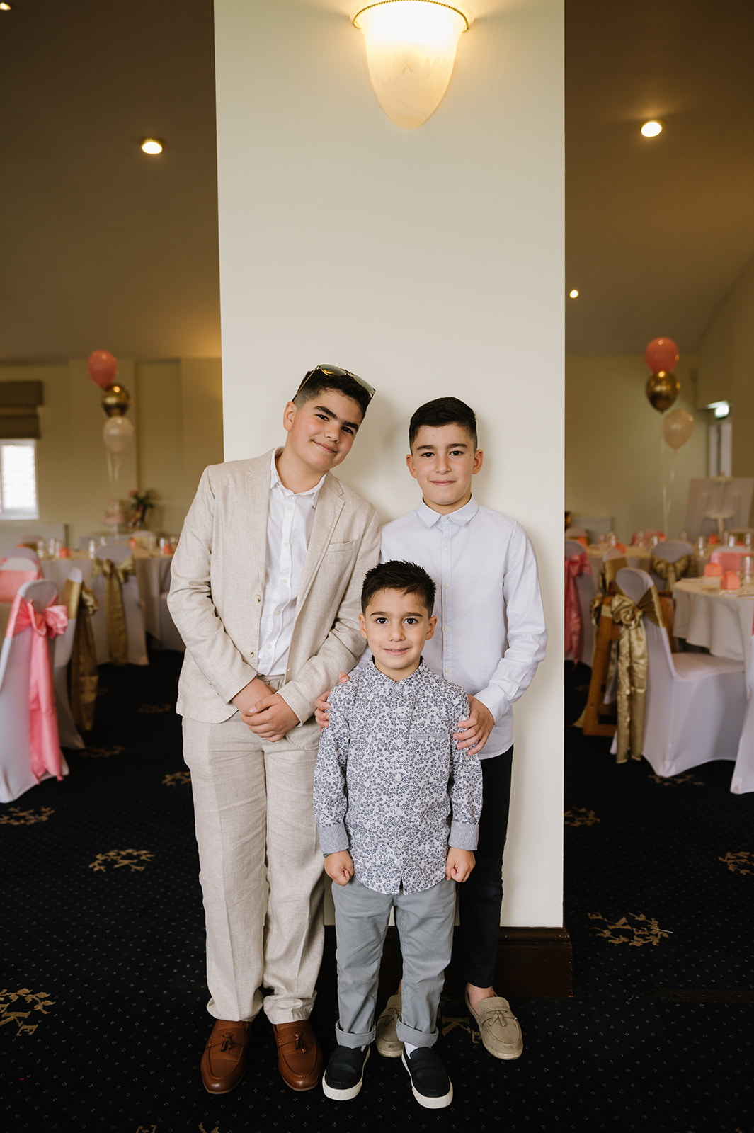 little boy guest dressed smartly for a greek orthodox christening