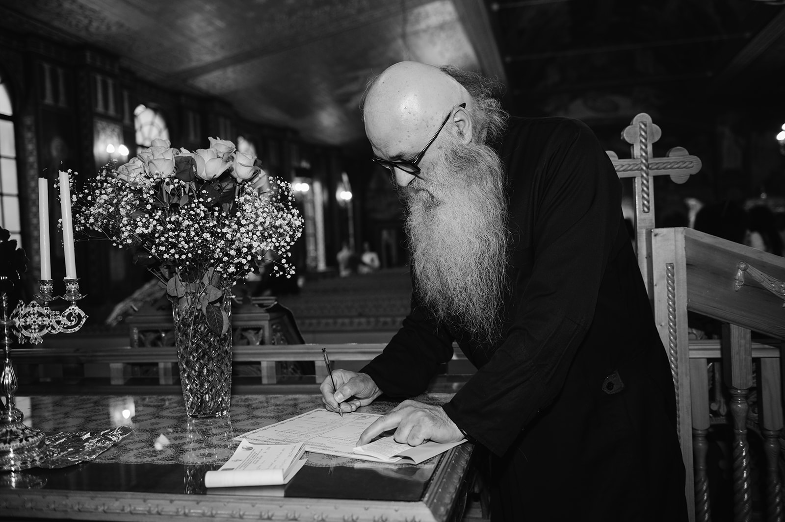 priest signing the christening documents