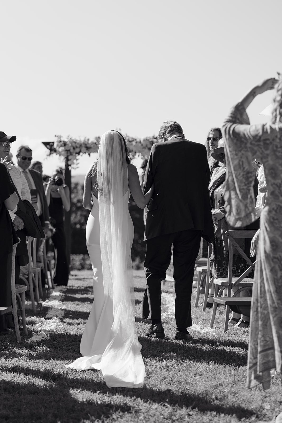 Bride walking down aisle with dad emotional