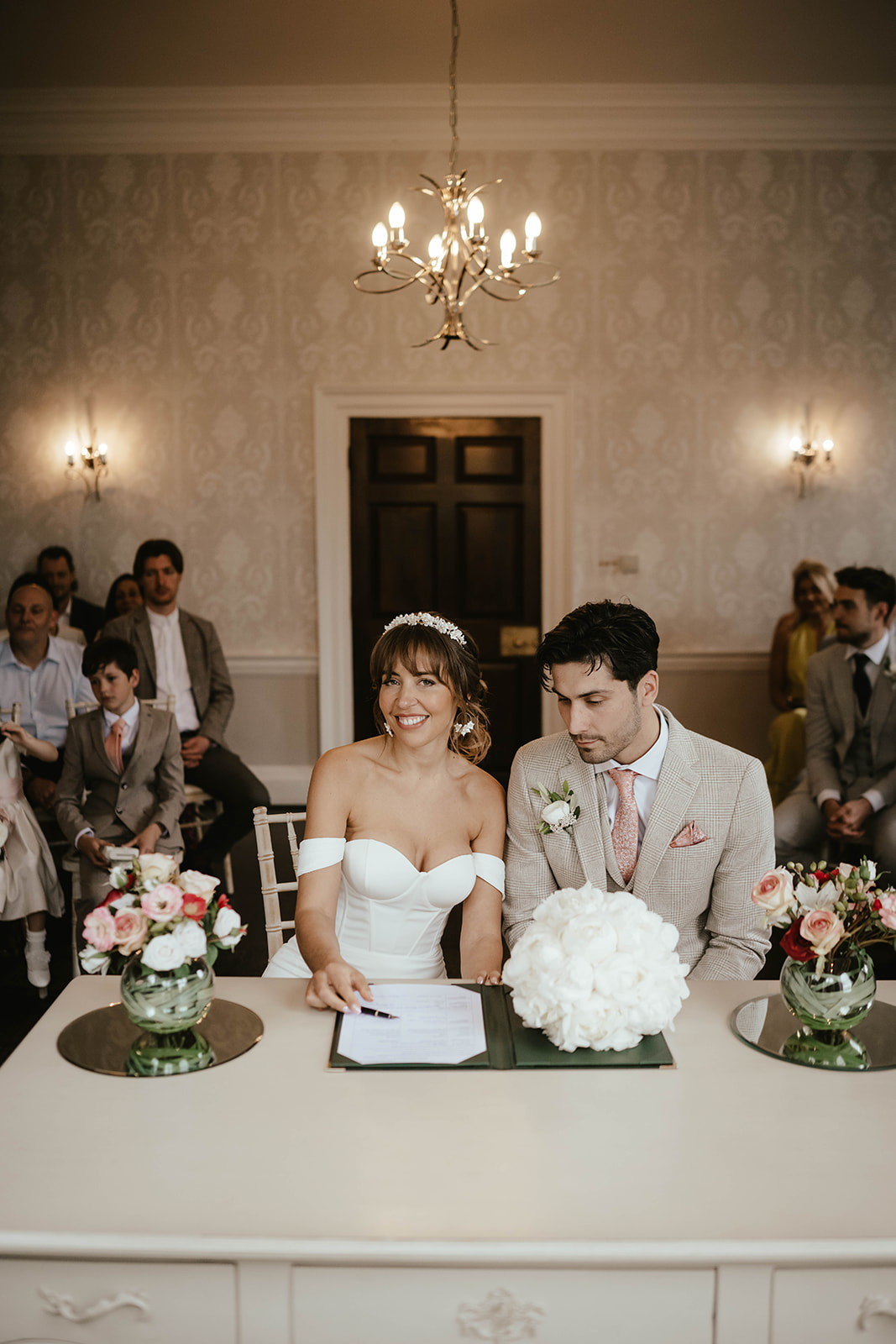 Couple signing the wedding book at Morden Park House Registry Office