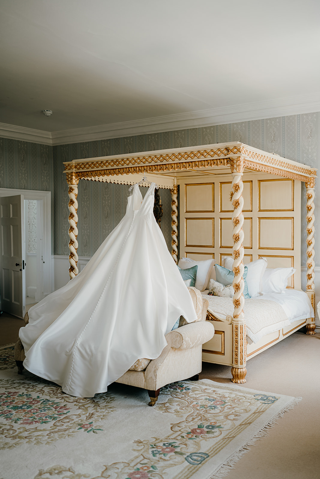 Bridal dress hanging on the stunning four poster bed in Norwood Park's bridal suite