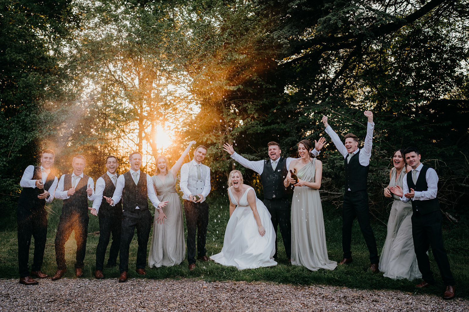 Bridal party champagne spray at sunset