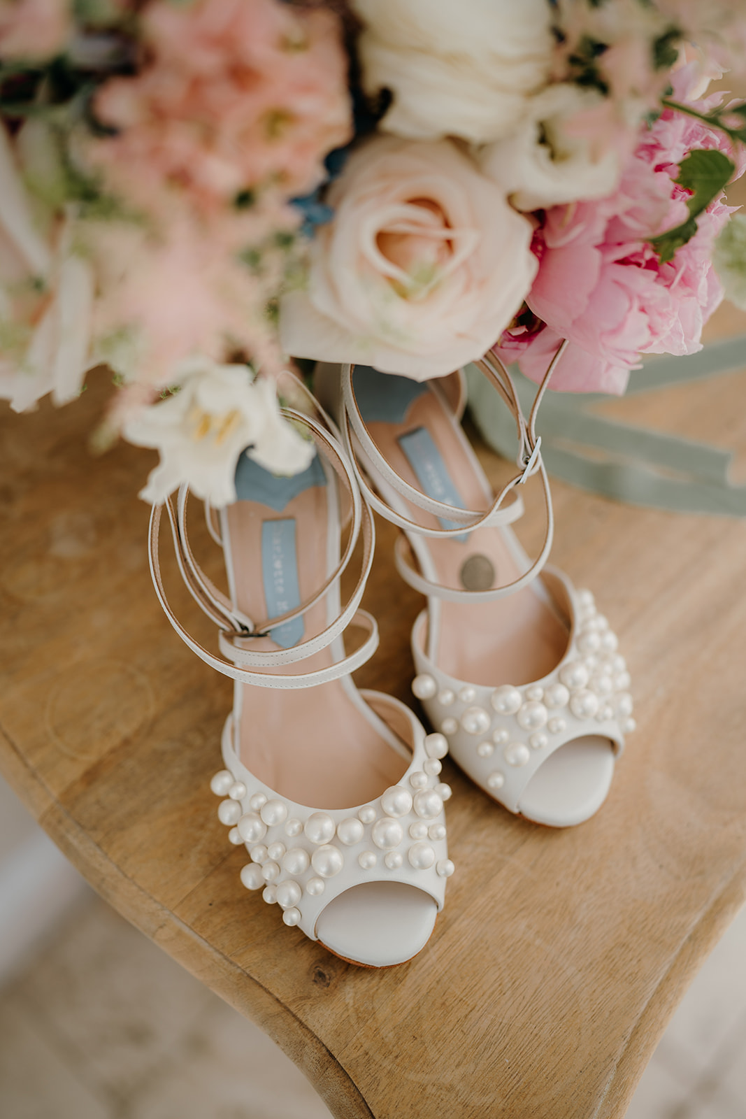 Bridal shoes and bouquet on morning of the wedding