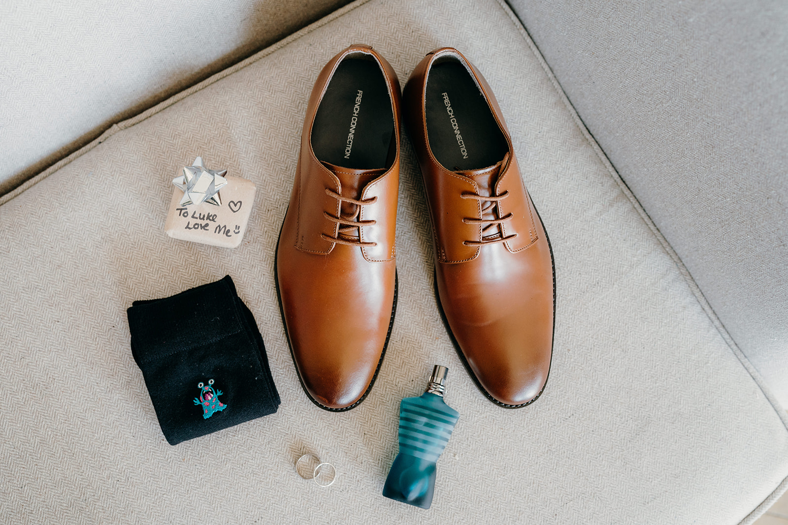 Grooms details with shoes and aftershave