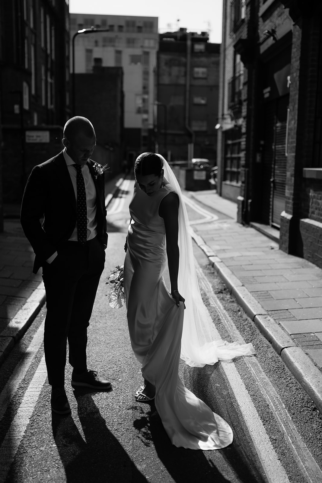 unique, cinematic wedding portrait in black and white of bride and groom outside of Shoredtich Studios