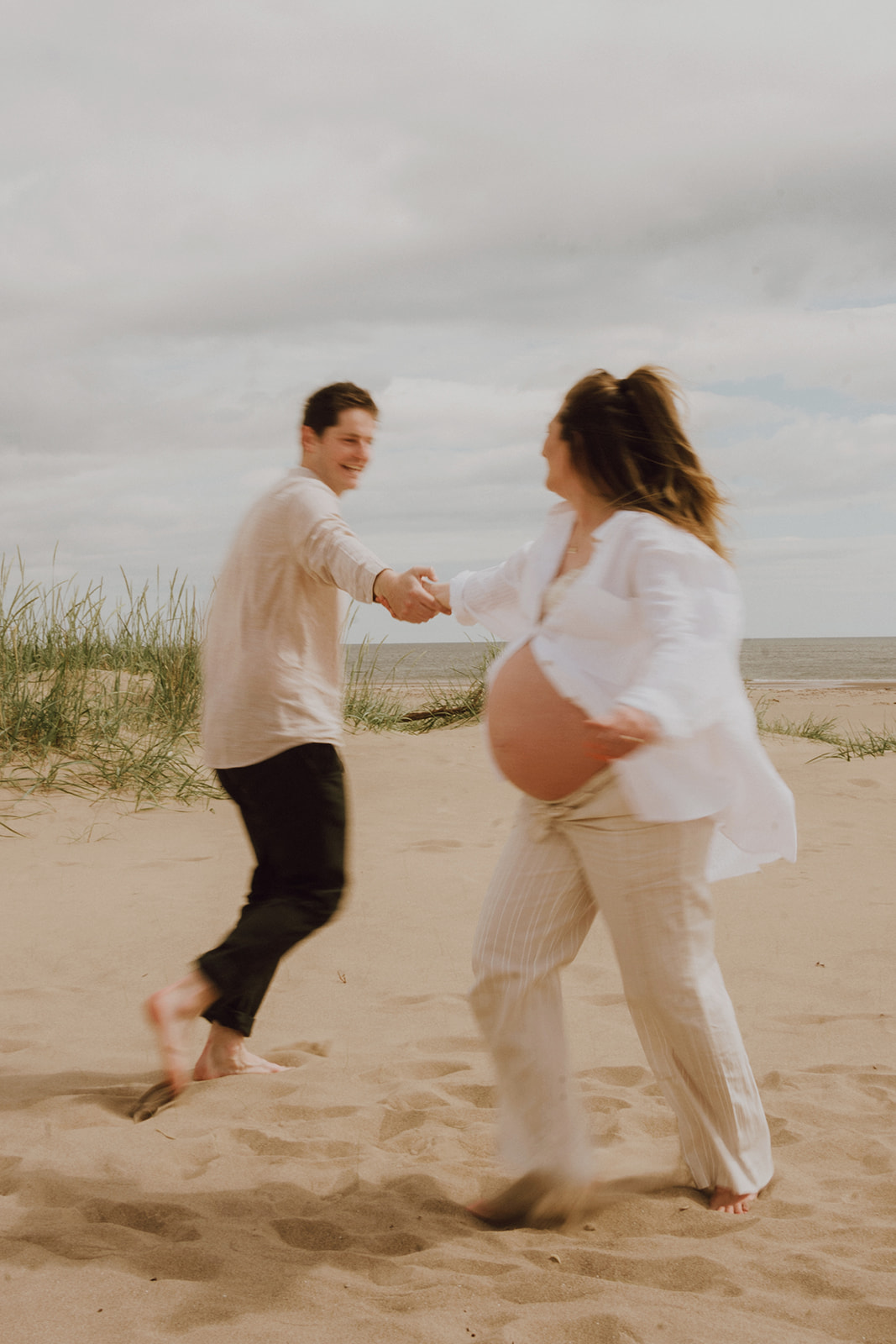 Couple dance together at Tentsmuir Sands during photoshoot