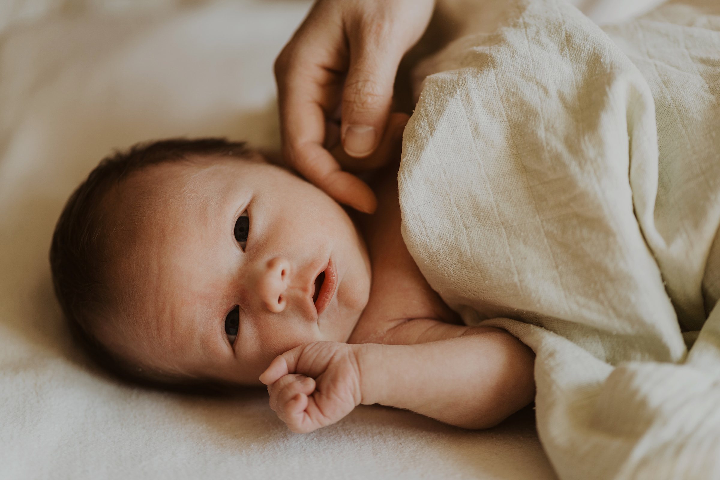Baby smiles during Edinburgh newborn photography session