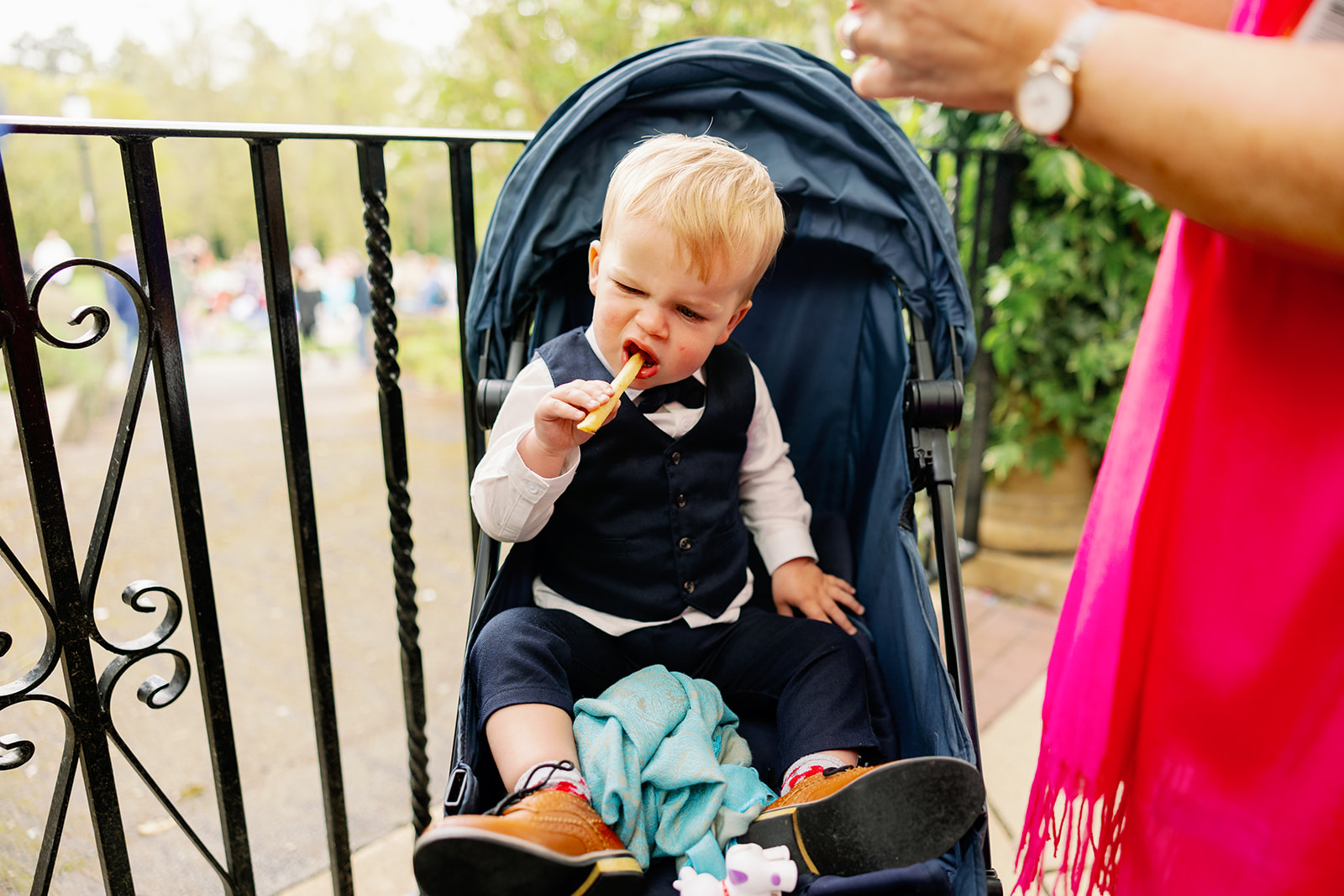 A child eating canapes on a wedding day 