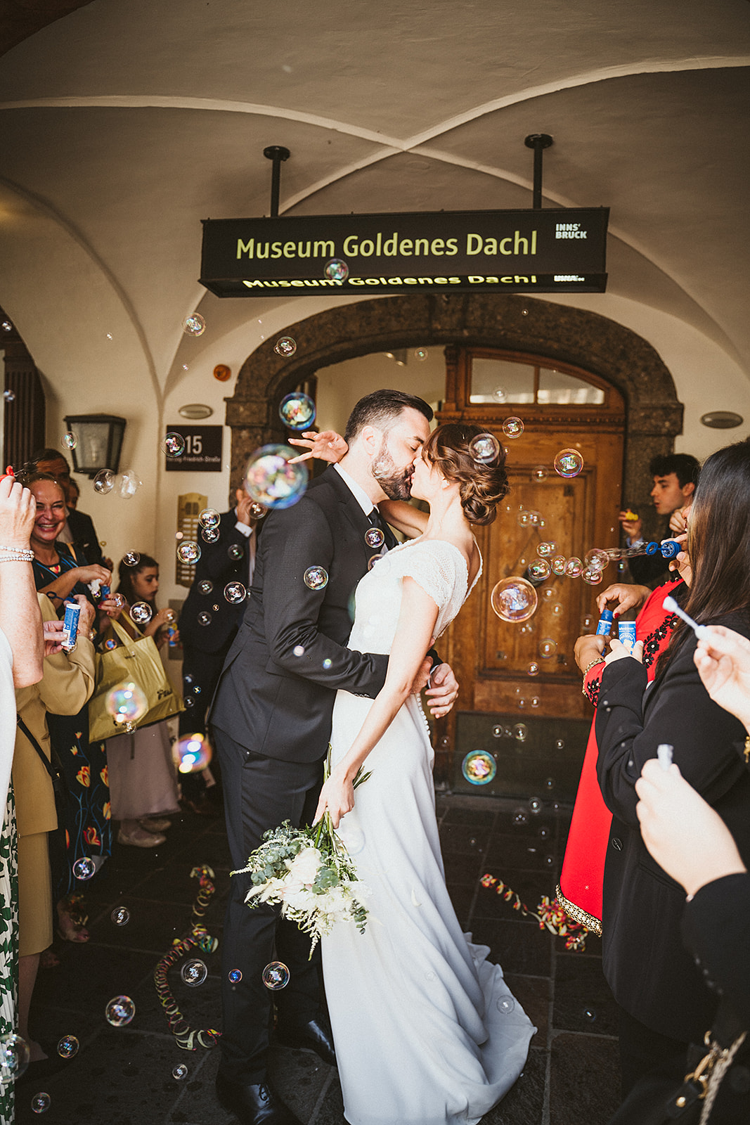 A bride and groom in front of the registry office for civil wedding in the city of Innsbruck in the Tyrol