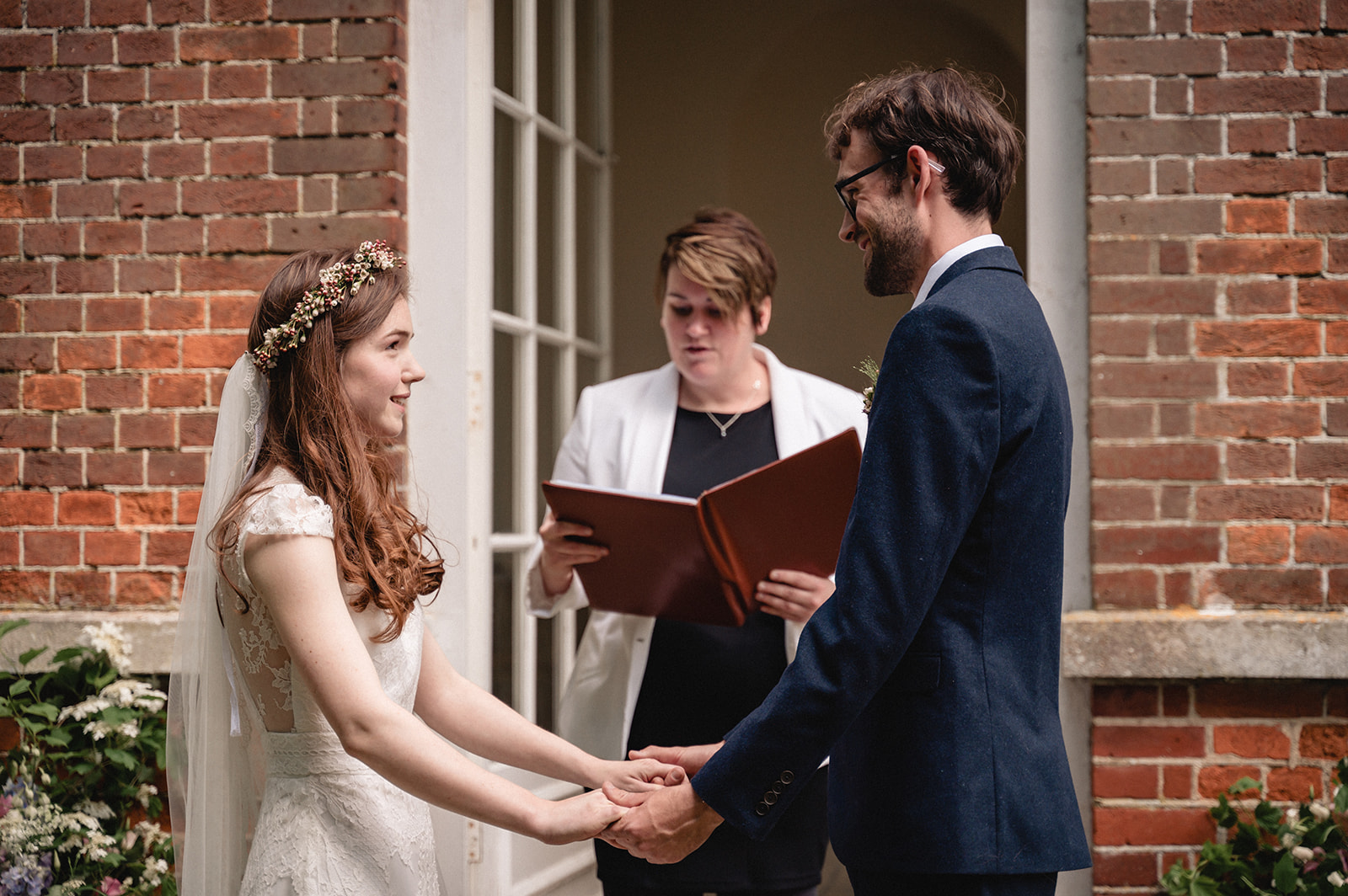 Eleanor and Hartley exchanging vows during the  wedding ceremony at the Organ House at St. Paul's Walden Bury