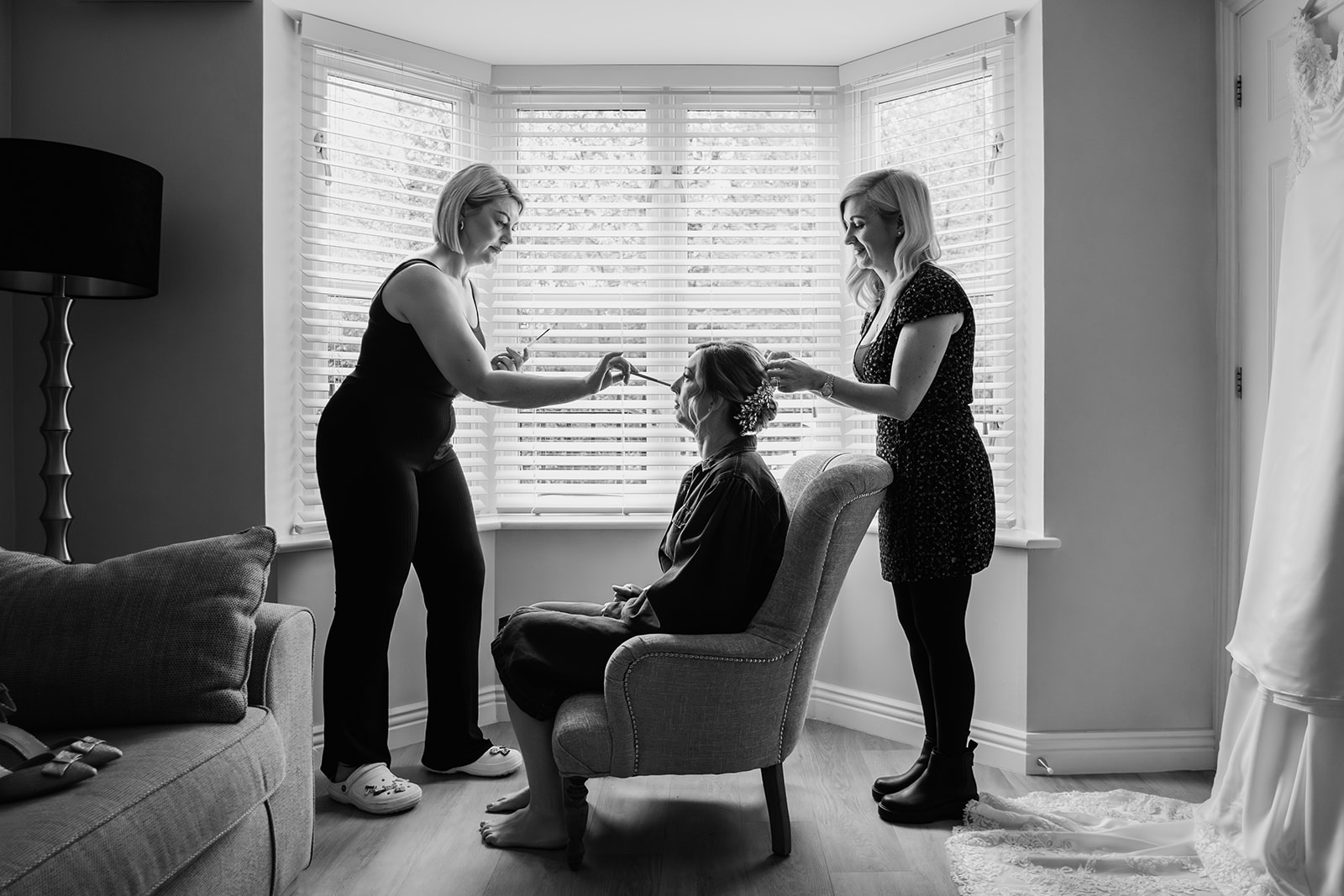Silhouette of bride having hair and makeup done