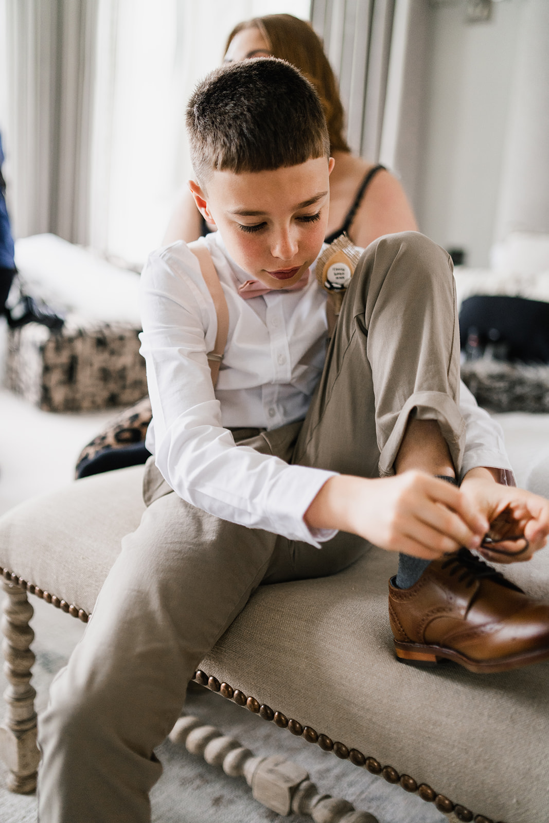 Pageboy tying up his shoes