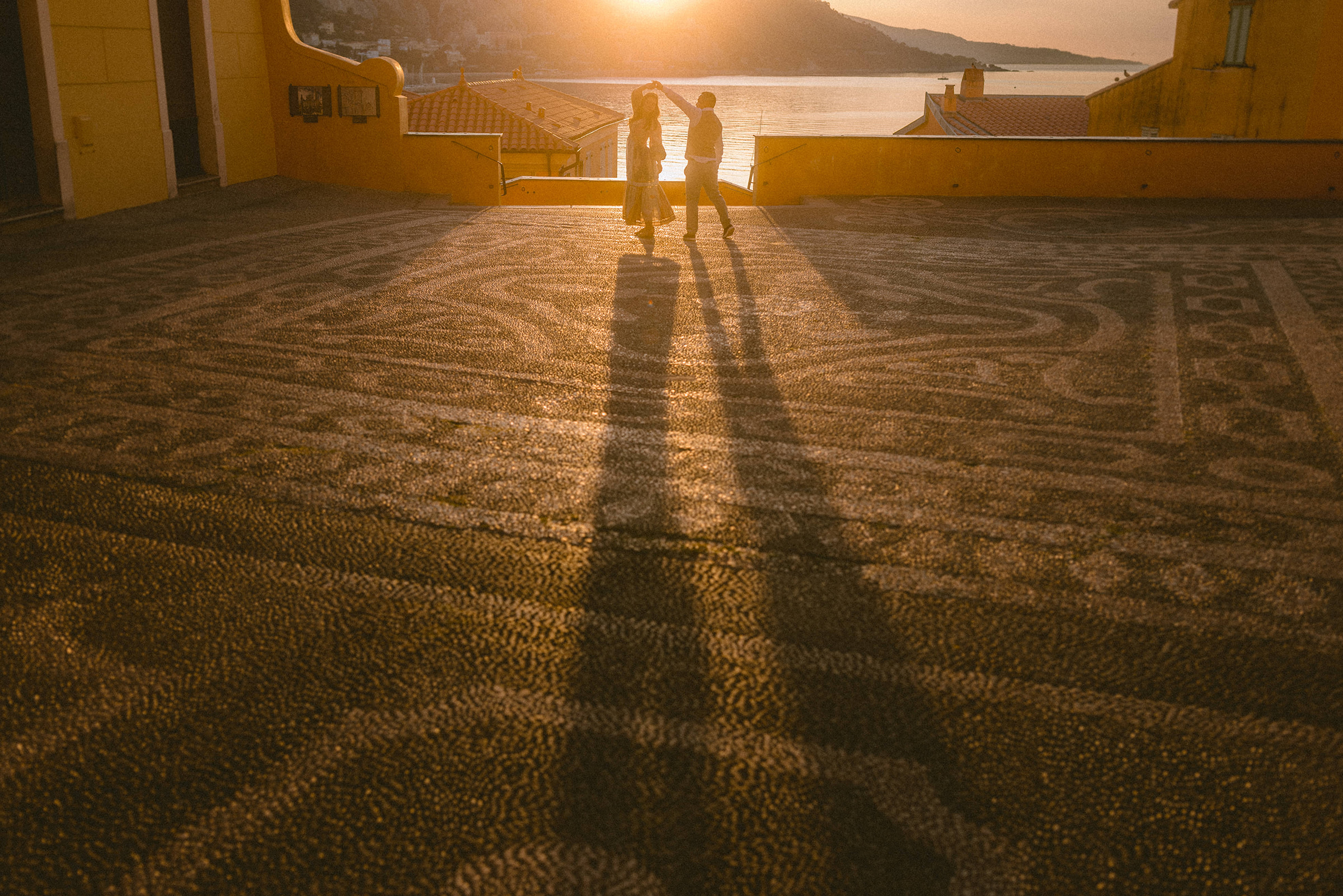 A couple dance during sunrise in Menton, french riviera