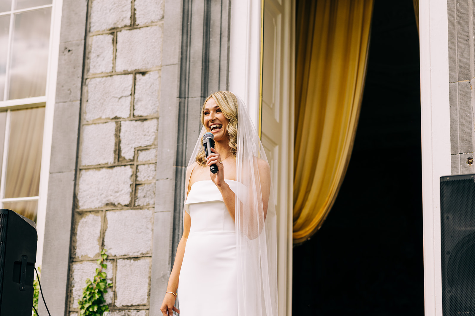bride delivering her bride's speech standing at the doorway to Castle durrow