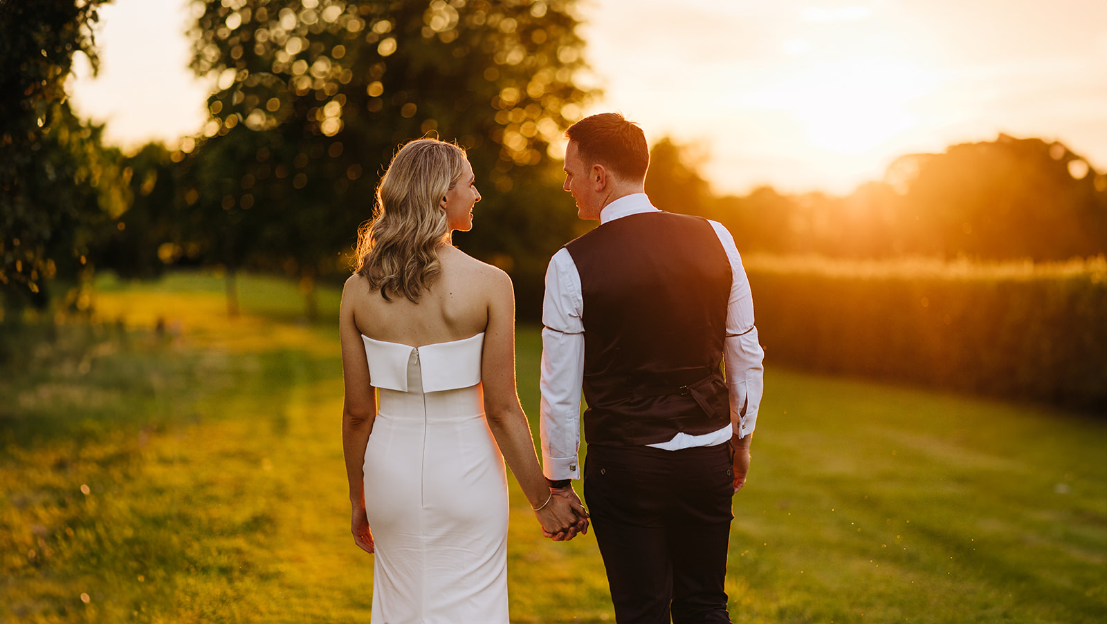 bride and groom in castle durrow grounds with sunset behind them