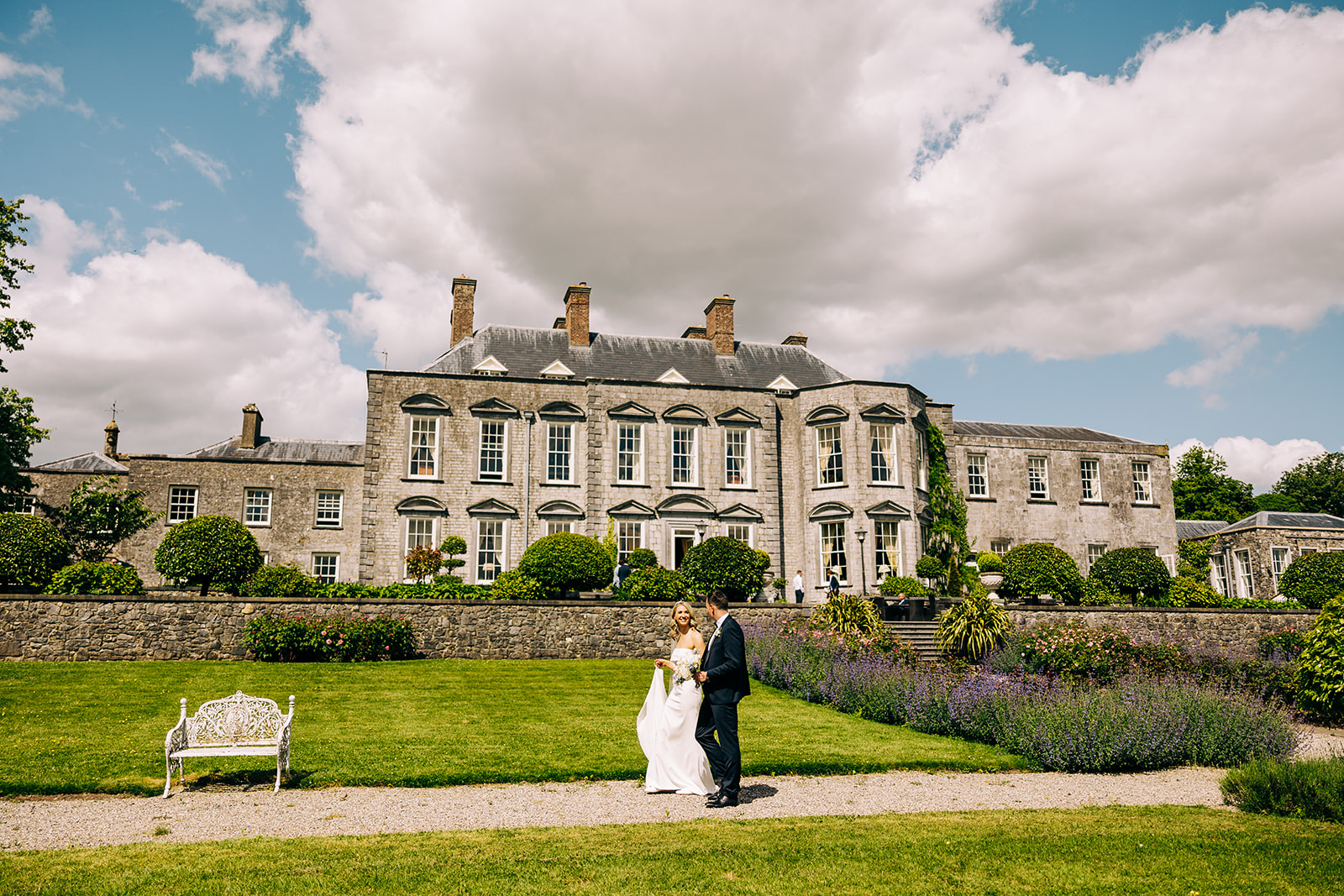 bride and groom with castle durrow in the background