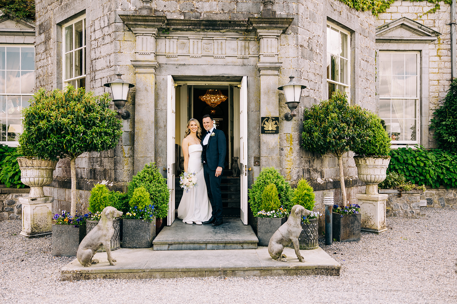 bride and groom pose at the doorway to the stunning castle durrow 