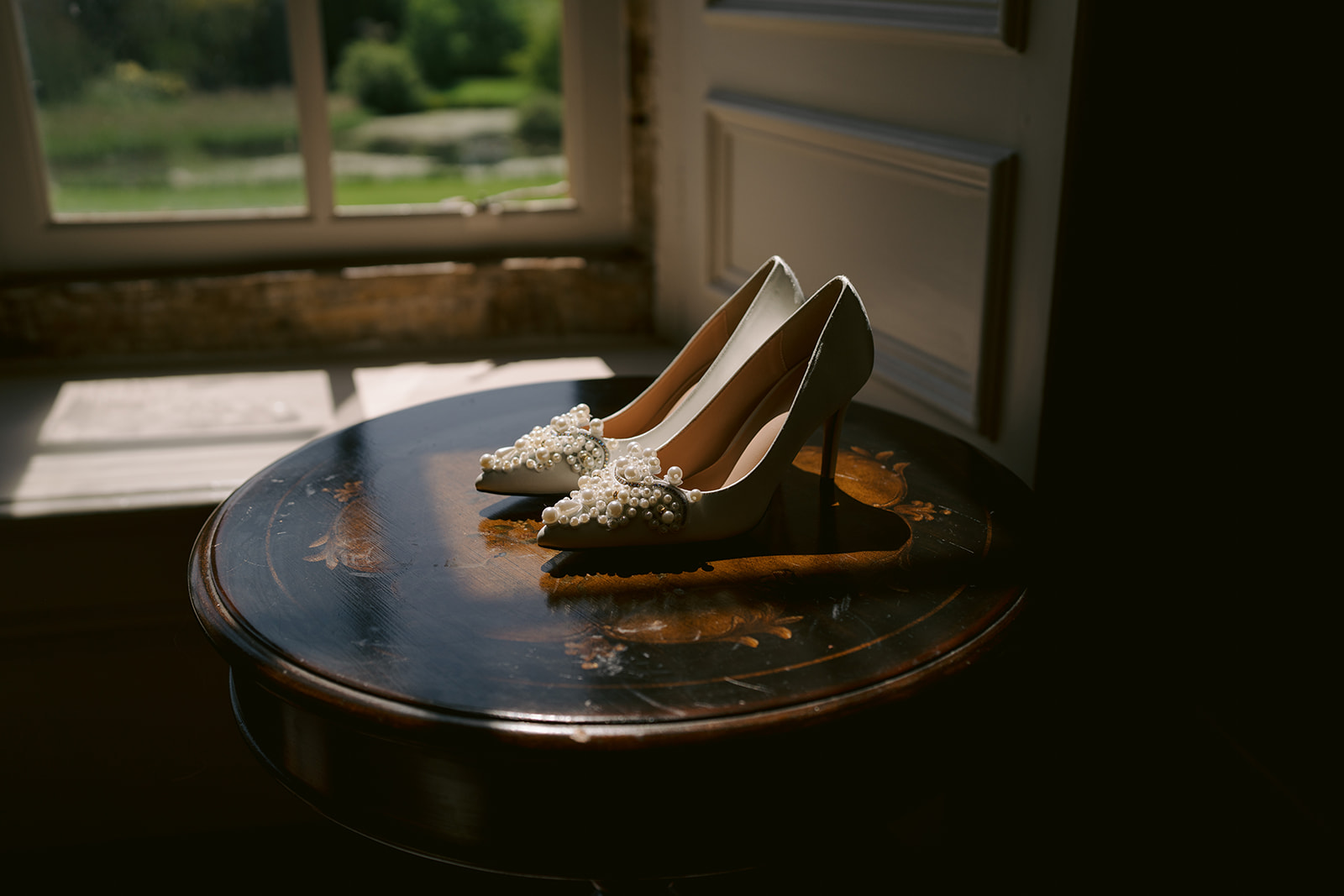 brides wedding shoes in the window on a table