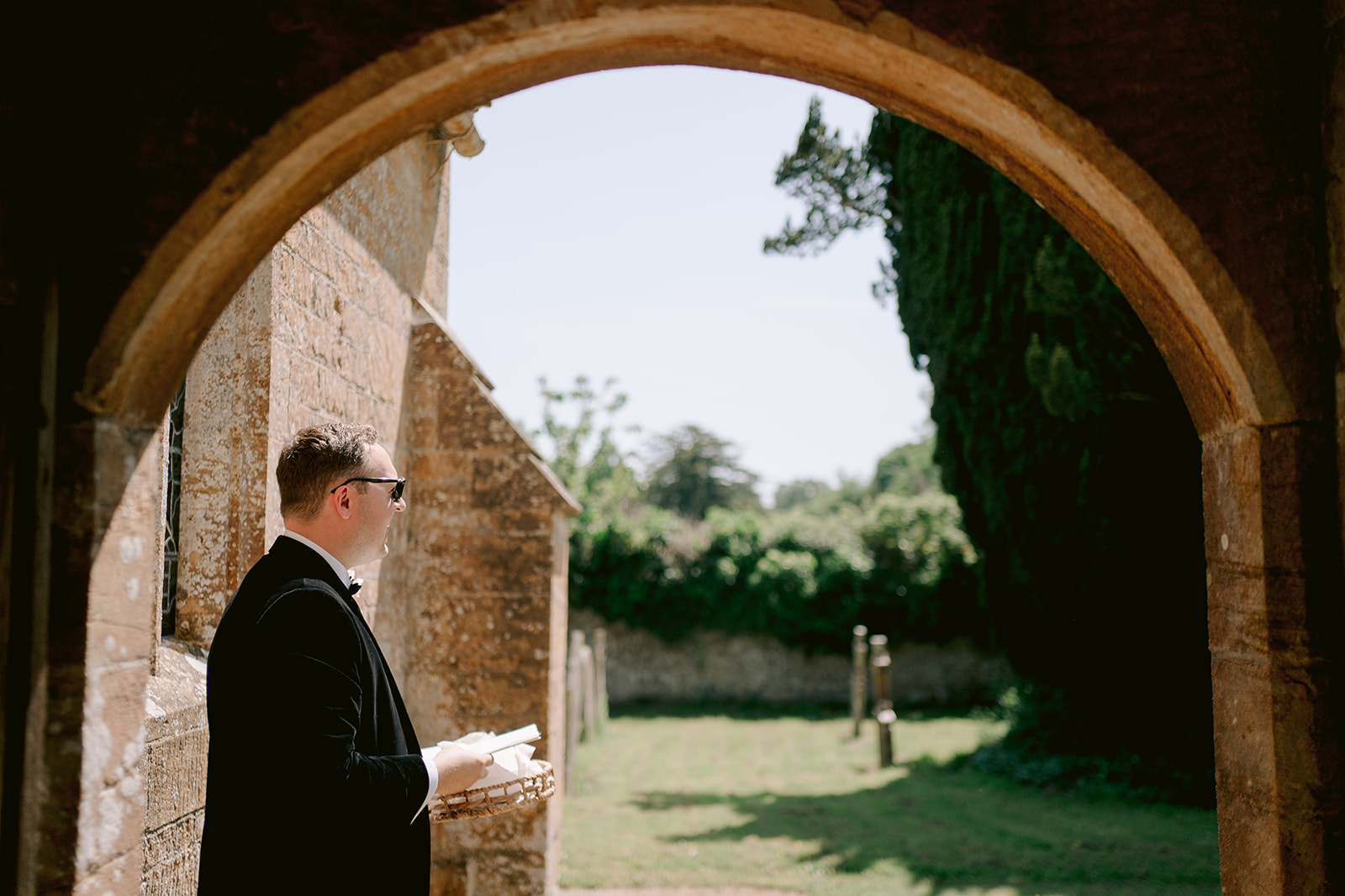 groom welcoming guests to wedding ceremony