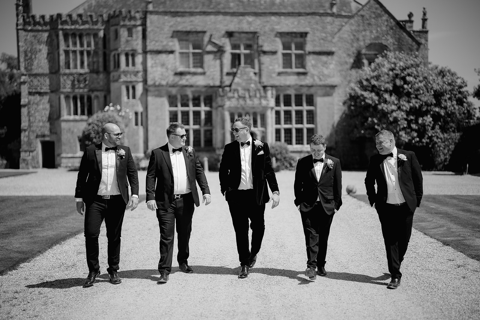 groomsmen walking outside brympton house