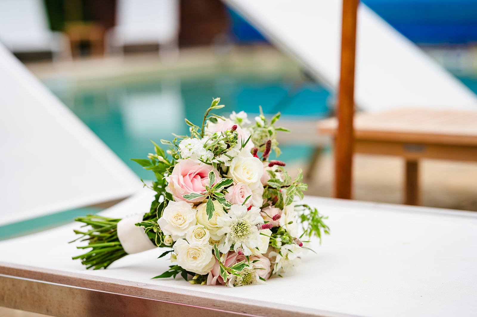 pink and white bouquet on sunbed