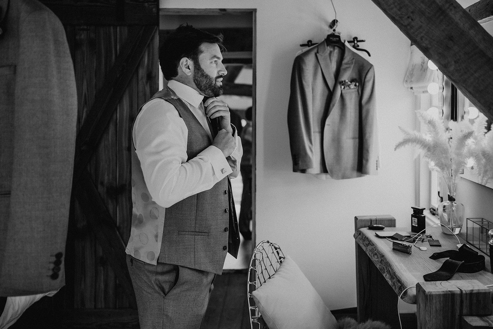 Black and white groom prep photo at a summer wedding at Silchester Farm