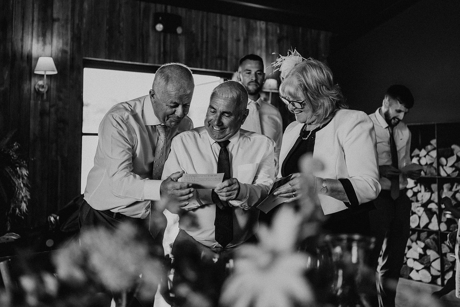 Black and white photo of guests laughing together at a summer wedding at Silchester Farm