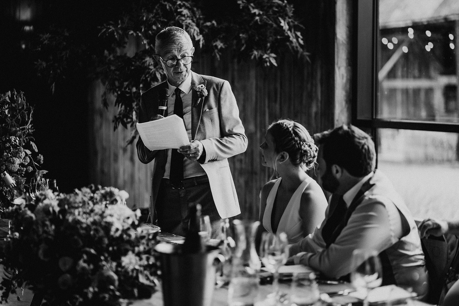 Black and white photo of the father of the bride giving his speech at a summer wedding at Silchester Farm