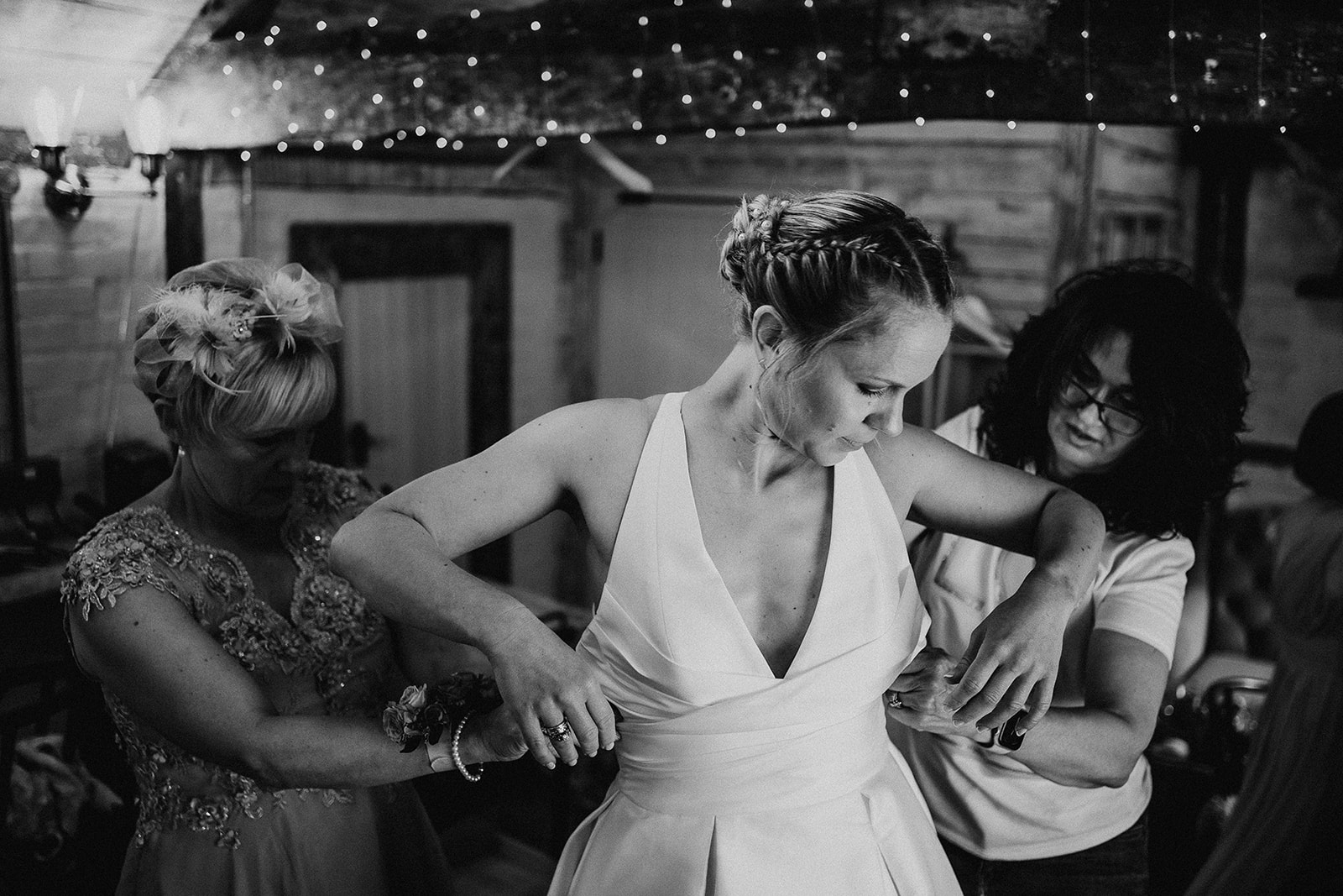 Bride gets into her dress at a summer wedding at Silchester Farm