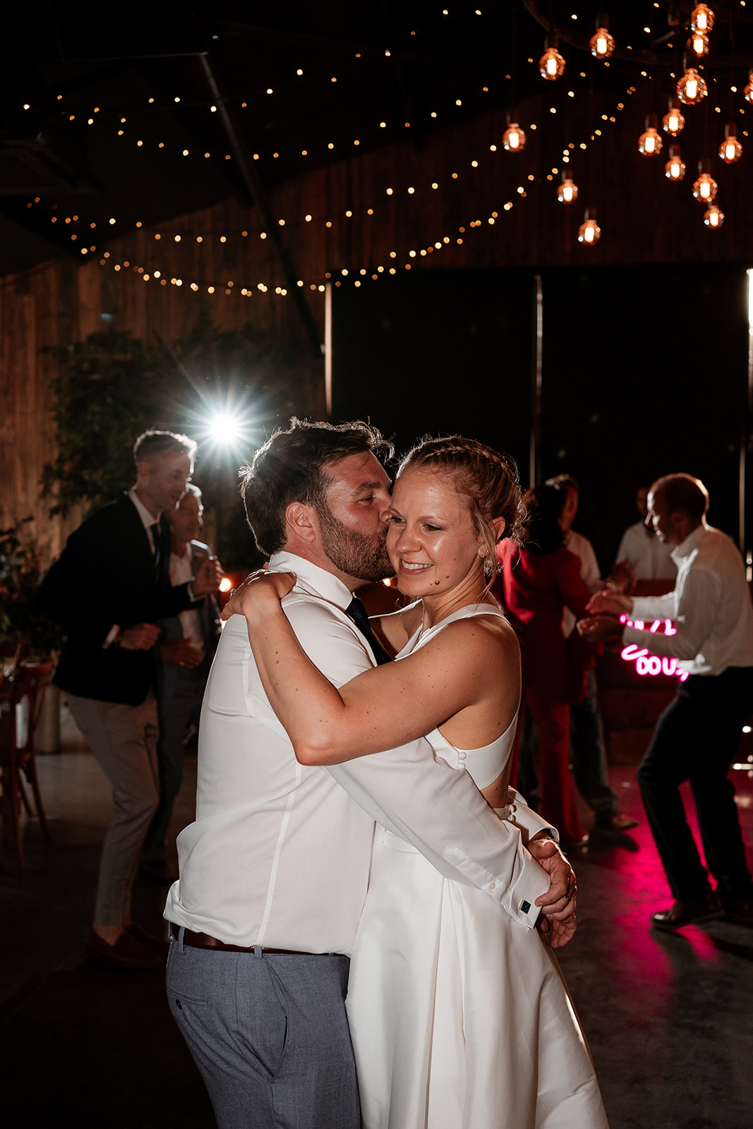 Bride and groom share a hug on the dancefloor at a summer wedding at Silchester Farm