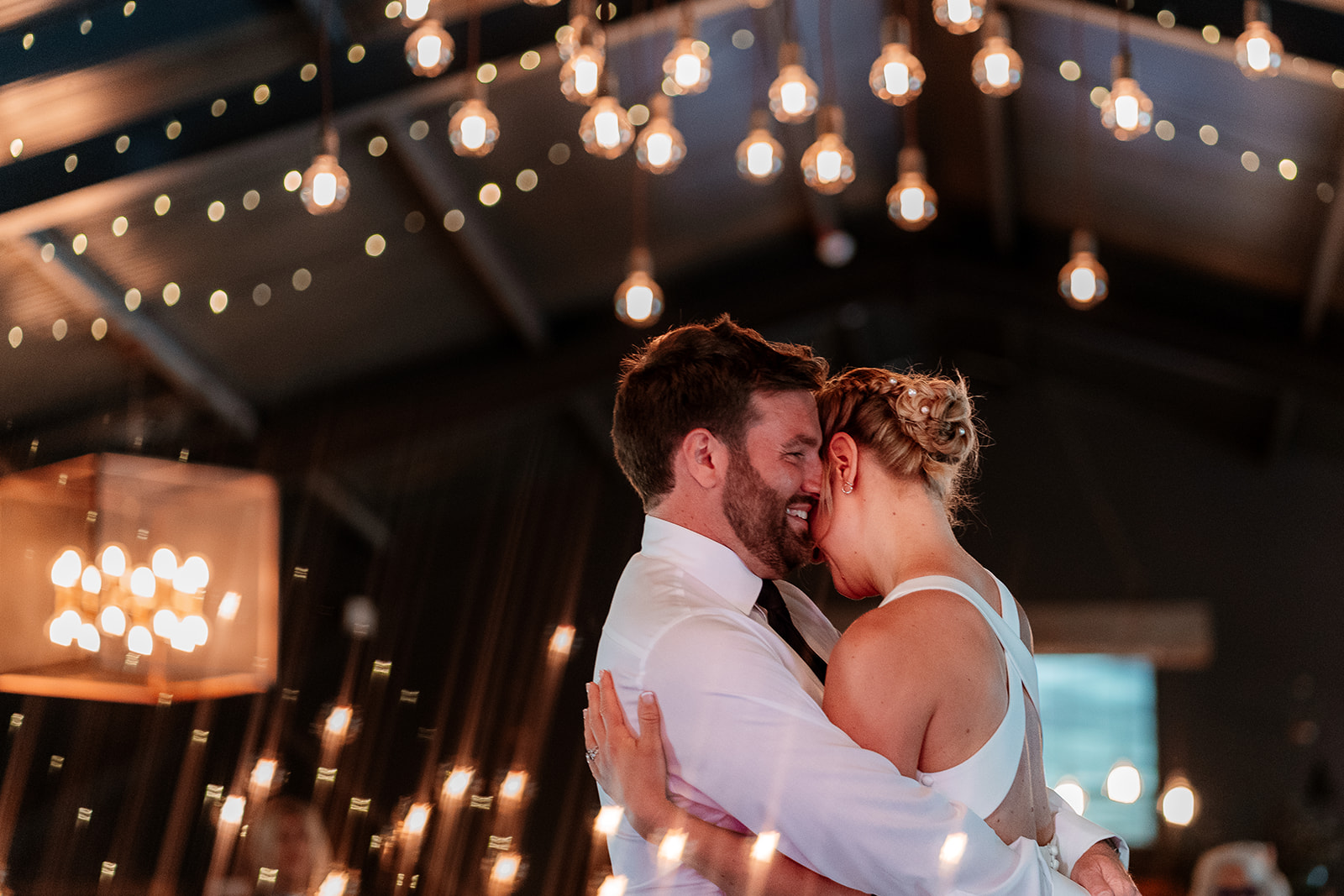 First dance under the fairy lights at a summer wedding at Silchester Farm
