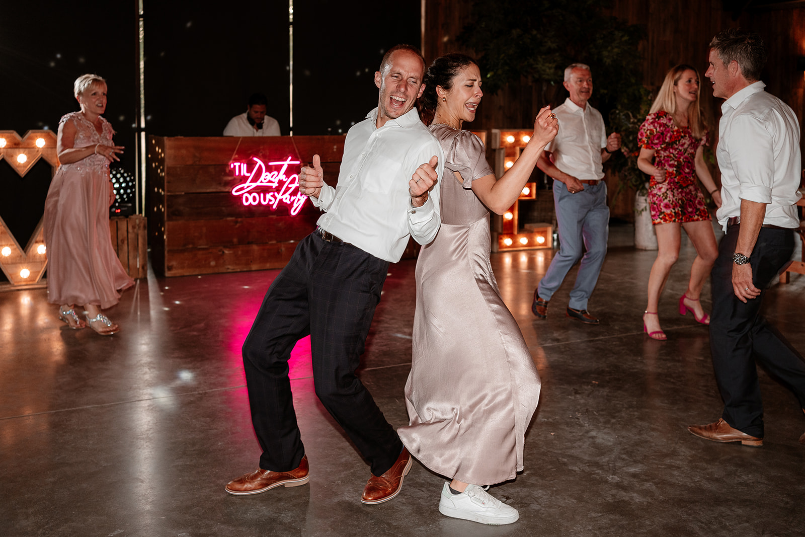 Guests dance together at a summer wedding at Silchester Farm