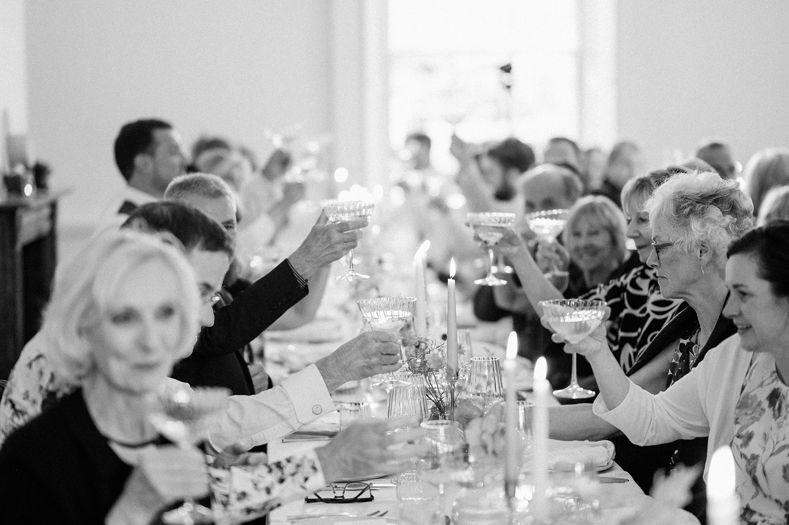 guests cheering at speeches during wedding reception at aswarby rectory
