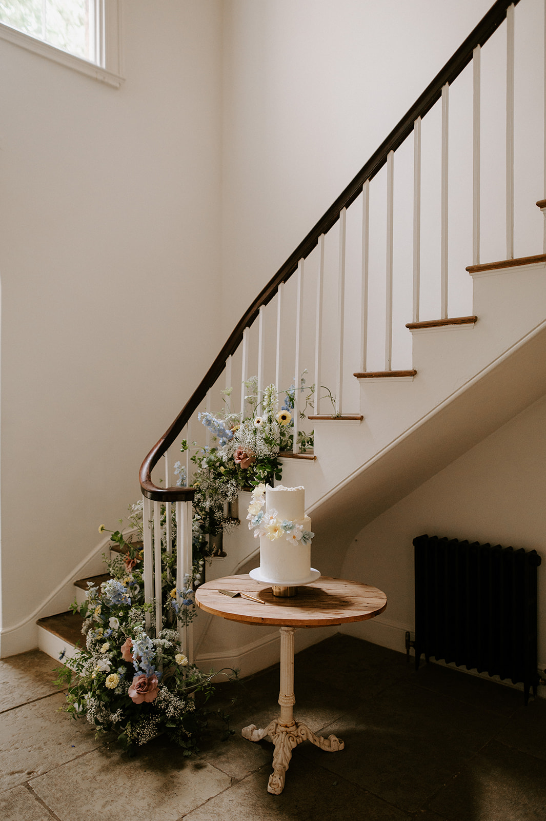 wedding cake next to staircase at aswarby rectory