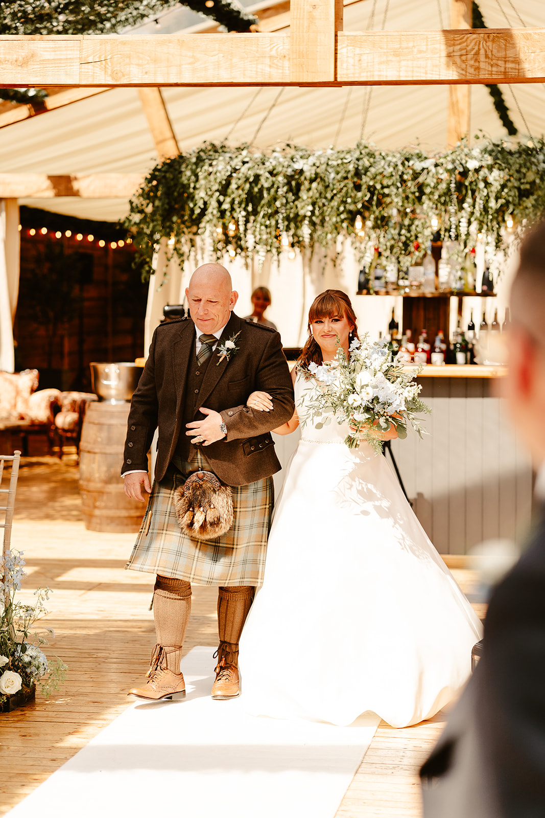 Bride walking down the aisle with her father at Elrick House Wedding Venue
