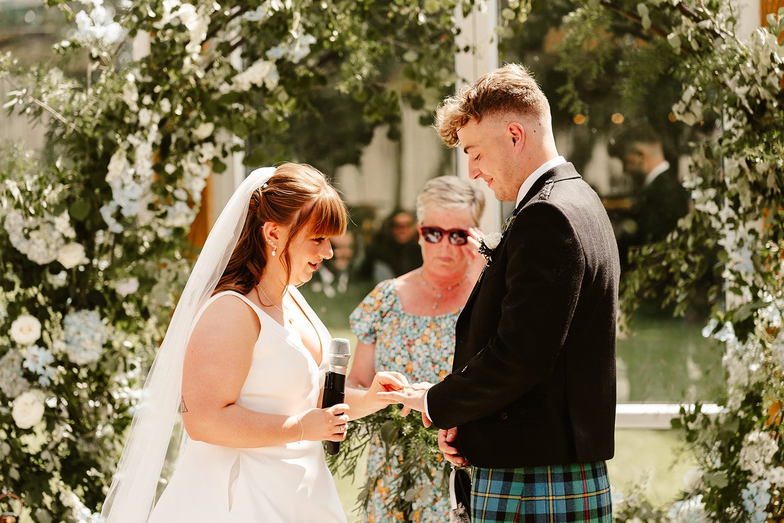 Couple exchanging wedding rings at Elrick House Wedding Venue