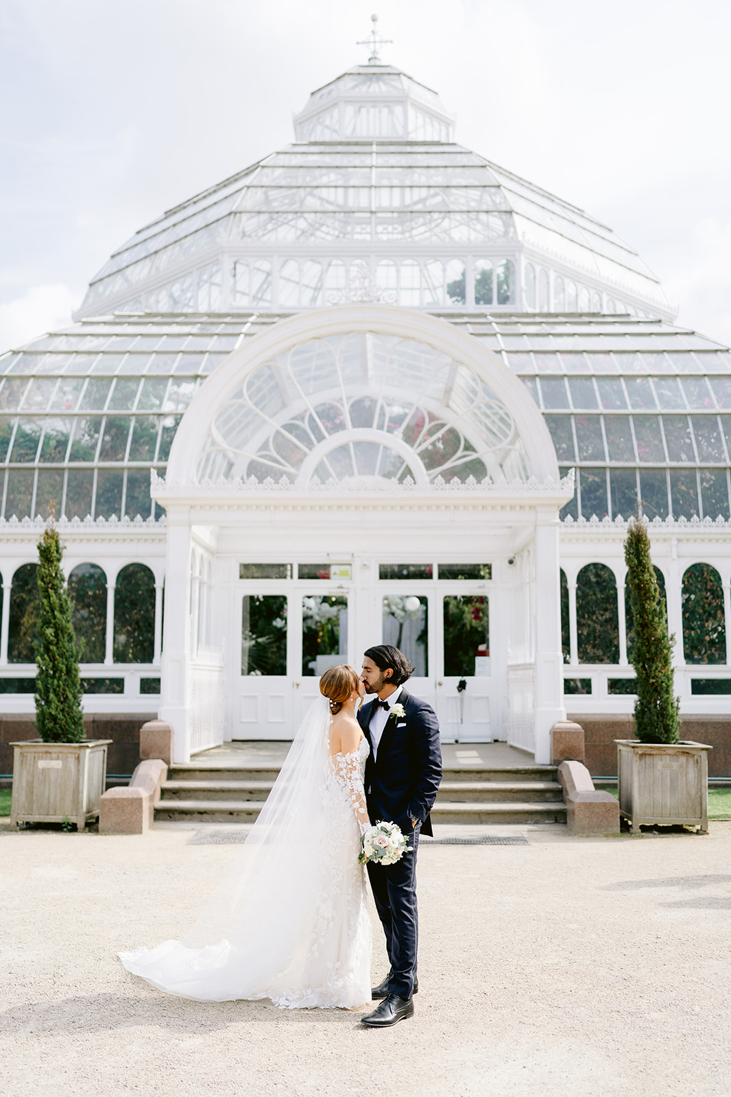bride in groom in front of sefton park palm house