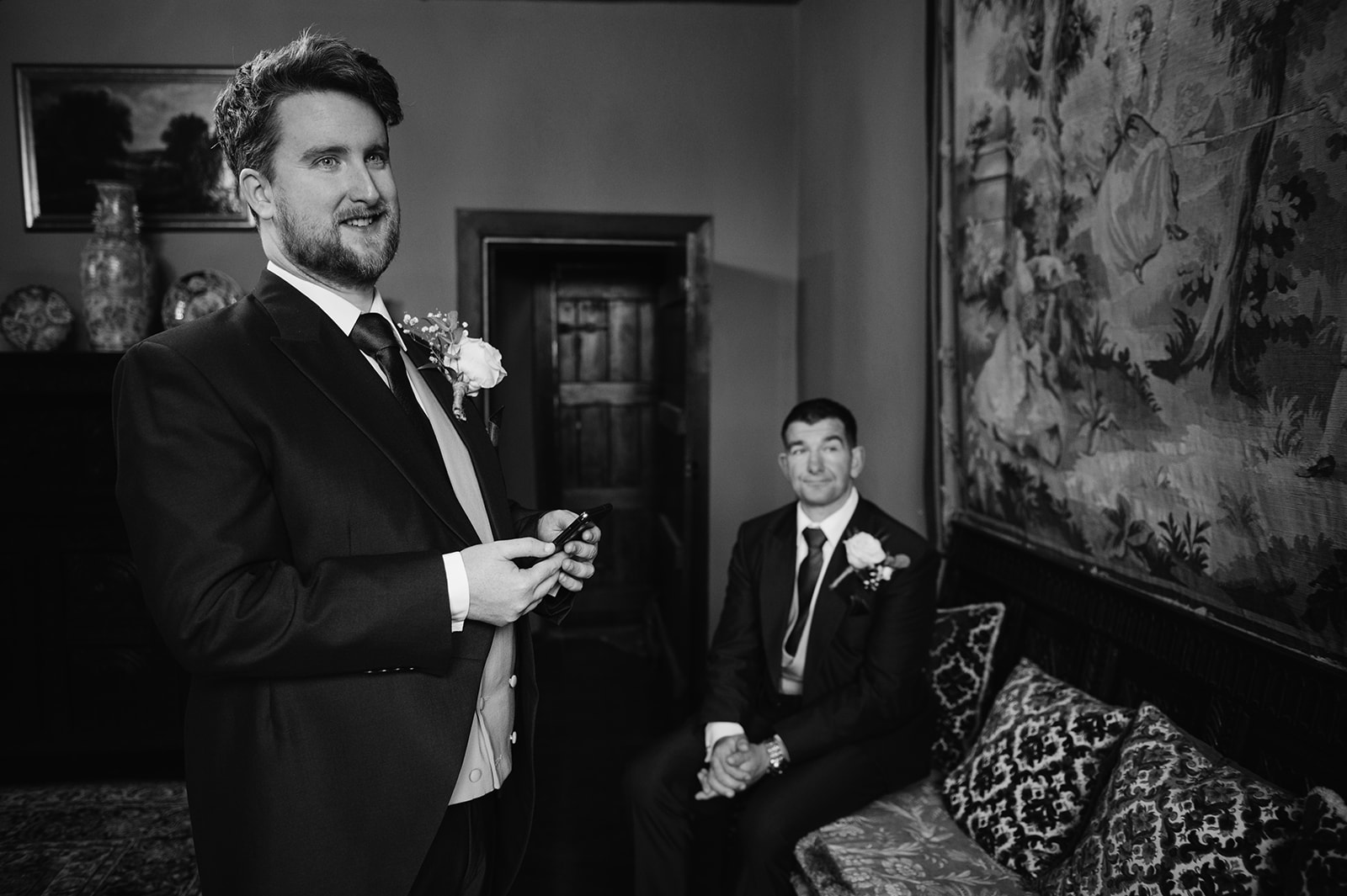 The groom and groomsman waiting in Chenies Manor for the wedding to begin.